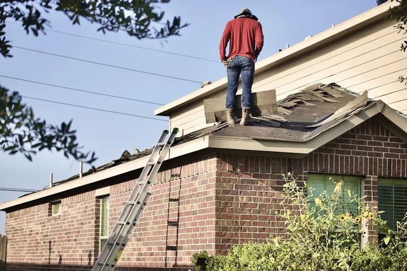 Professional roofer working on a residential roof in Indio